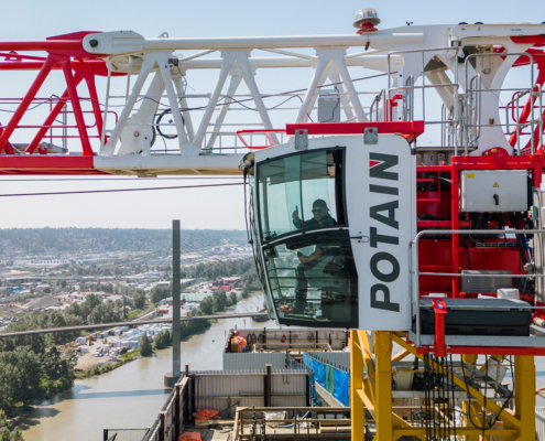 crane operation as a career: an operator gives a thumbs up from the cab of the crane