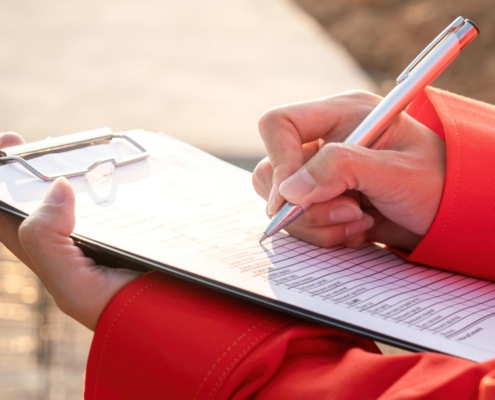 Crane operator writing on clipboard