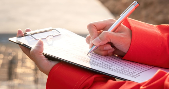 Crane operator writing on clipboard