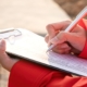 Crane operator writing on clipboard