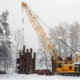 Mobile crane work in a park during snowfall. Work in bad weather conditions.